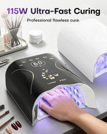 Nail tech curing a client's hand inside the black 115W high-power gel nail lamp. Ensures ultra-fast, professional flawless curing for acrylics and hard gels. The lamp's digital screen is blank, sitting next to a white model on a tidy manicure station