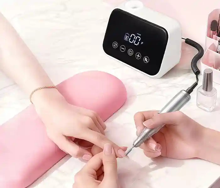 Professional Gugusure smart touch nail drill being used with a pink ergonomic arm rest for precision cuticle prep.