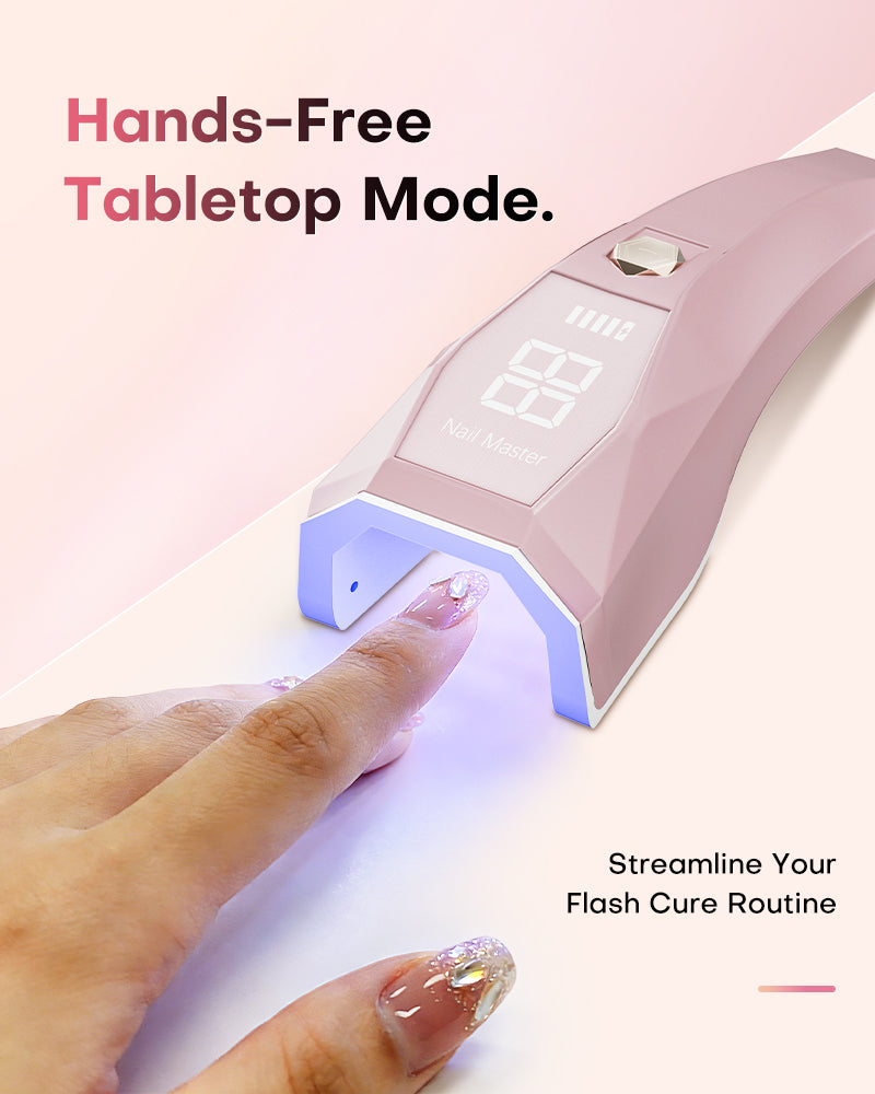 Hands-free tabletop mode. Pink Gugusure nail lamp standing upright on a desk to streamline your flash cure routine.