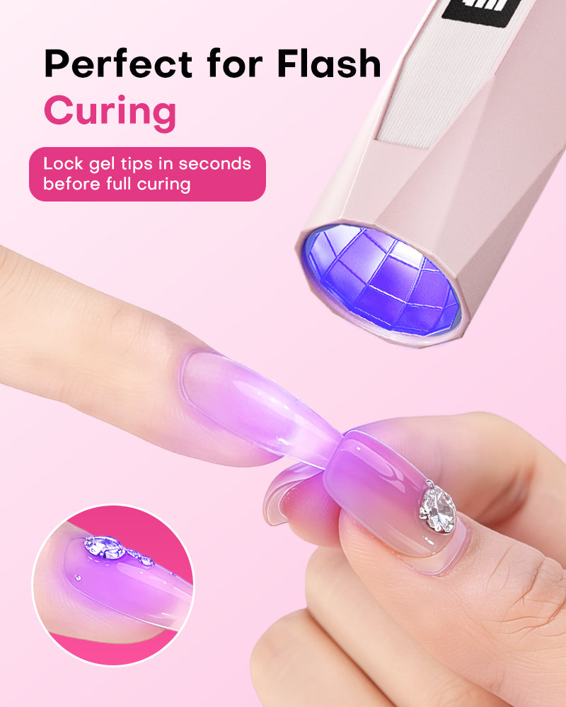 Hand using a Gugusure pink mini UV LED nail wand to precision cure and lock a purple gel tip in place.