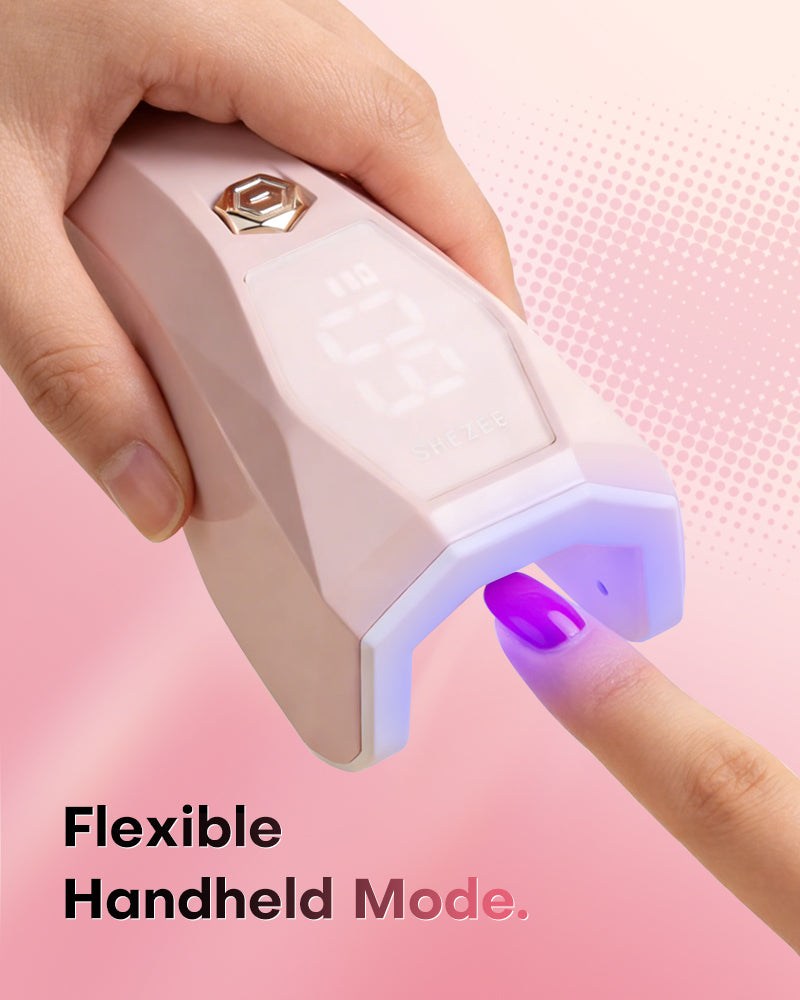 Ergonomic pink Gugusure cordless gel nail dryer in handheld mode, perfect for precision flash curing at home.
