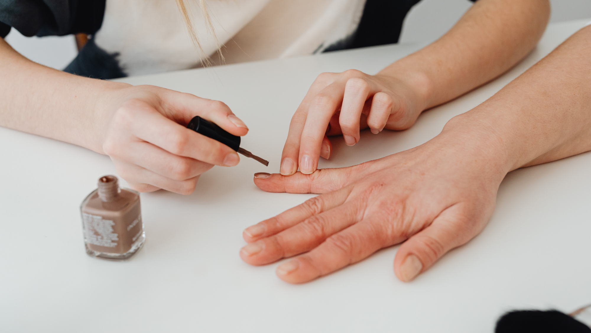 A mother and daughter enjoying a DIY home manicure session with Gugusure nail polish and tools. Family bonding beauty.