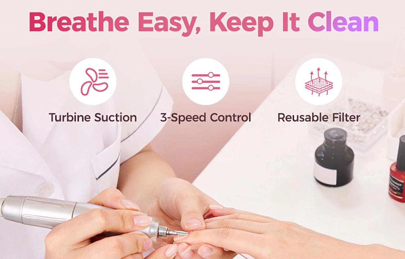 Nail tech filing nails over the pink alloy dust extractor. Features breathe-easy turbine suction, 3-speed control, and a reusable filter to keep the salon desk clean and dust-free.