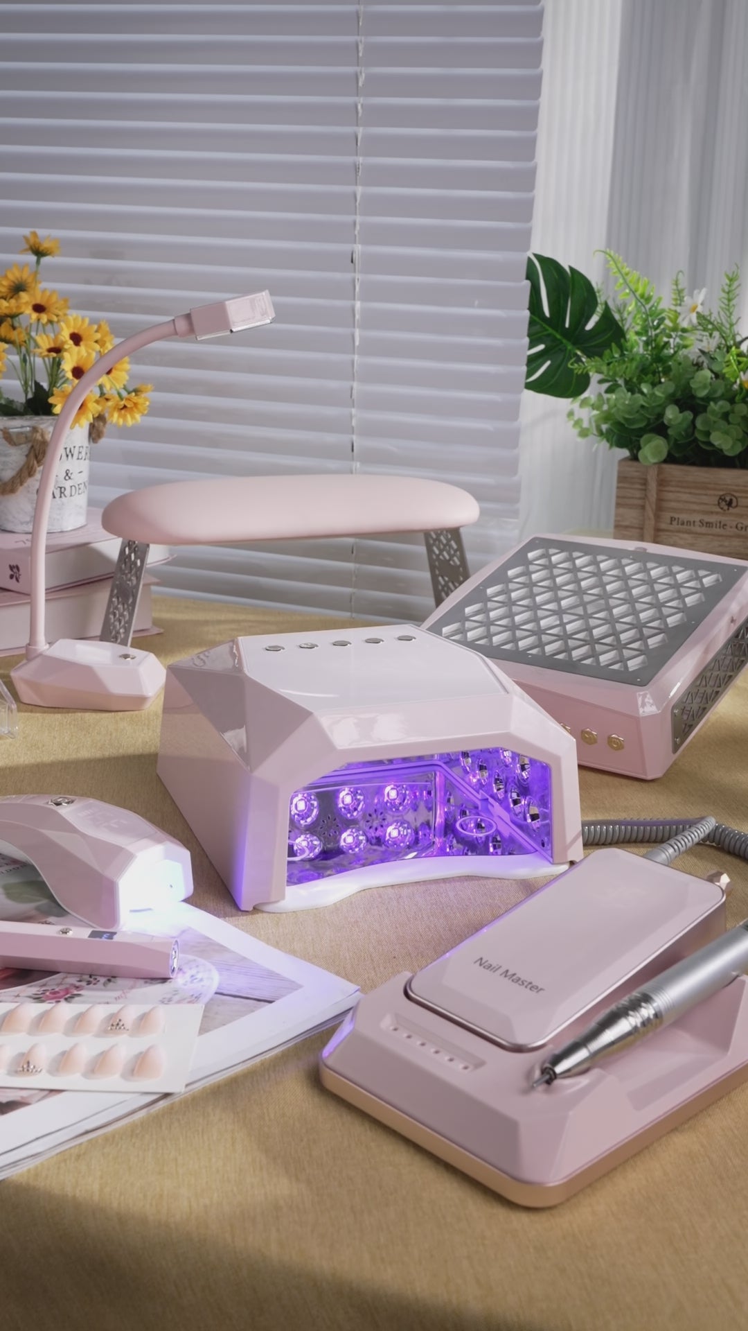 Aesthetic pink DIY manicure station setup on a desk, showcasing Gugusure professional nail tools and equipment.