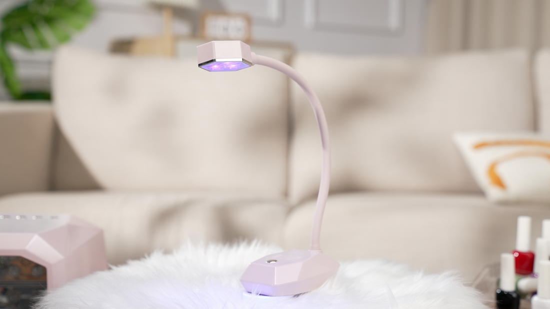 Cozy home salon setup featuring a pink freestanding Gugusure flexible desk nail lamp curing light on a fluffy white rug.