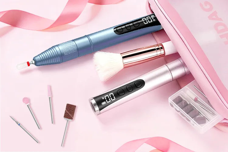 Portable electric nail drill pens in blue and rose gold packed in a pink travel case. Compact manicure tools for on-the-go use.